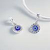 Sterling silver devil's eye charm bracelet featuring a round charm with an iridescent blue and black eye design