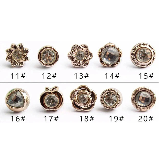 A collection of twenty elegant button brooch pins in various designs and finishes.