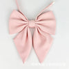 A pink butterfly ribbon tie set with a bow and a pointed shape.