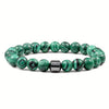 A bracelet made of polished green and black tiger eye lava map beads.