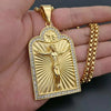 A gold-colored pendant necklace featuring a detailed depiction of the Christian cross and a figure of Jesus on a sunburst bac