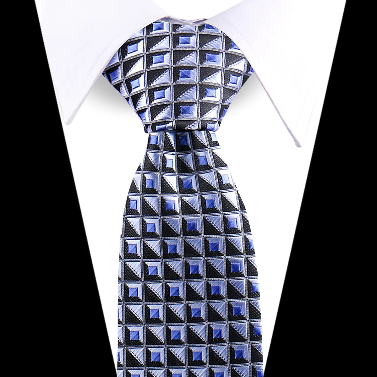 A close-up of an elegant men's floral paisley silk necktie with a blue and black geometric pattern.