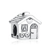 A sterling silver family tree charm jewelry piece shaped like a house with decorative elements.