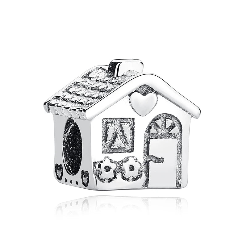 A sterling silver family tree charm jewelry piece shaped like a house with decorative elements.