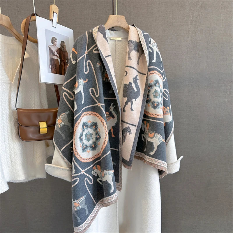 A gray and beige plaid cashmere scarf and shawl wrap displayed on a hanger against a neutral background.