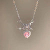 A delicate silver necklace featuring a sparkling pink heart-shaped zircon pendant.