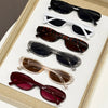 A collection of trendy leopard cat eye sunglasses in various colors and styles displayed in a light-colored box.