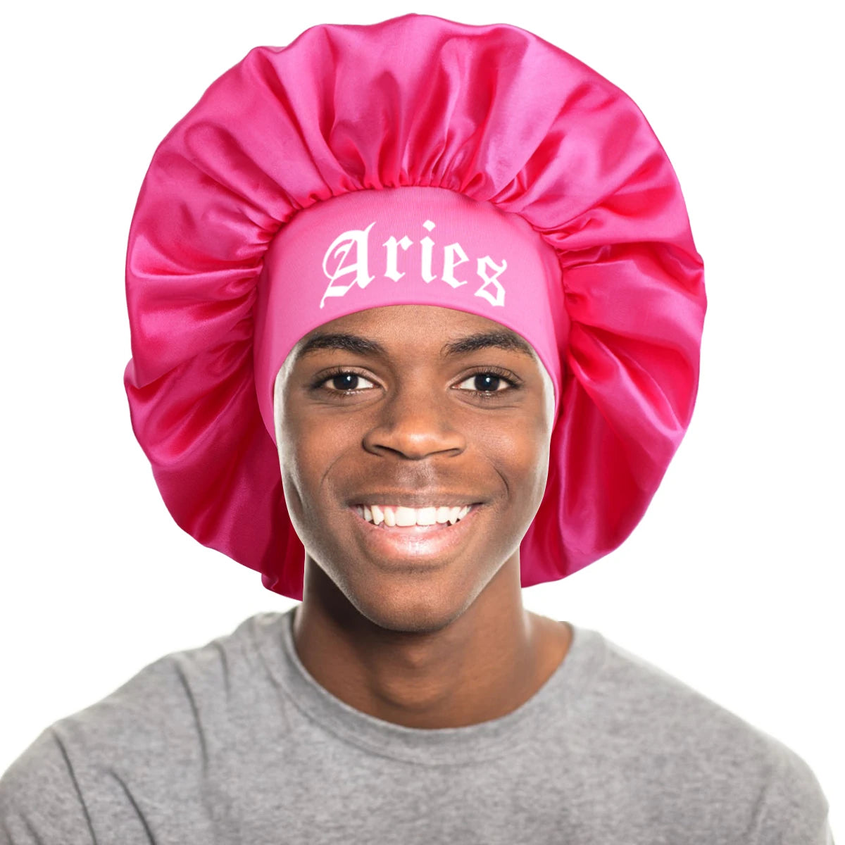 A young man wearing a pink satin sleep bonnet with an Aries wrap band.
