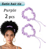 Purple satin hair ties scrunchies shown with a woman's curly hairstyle