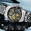 A stainless steel quartz wristwatch with a detailed dial and bracelet, shown on a dark surface.