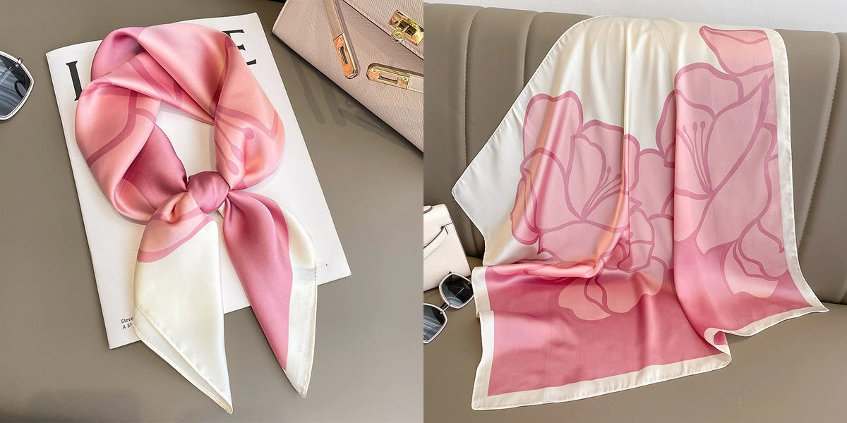 A pink floral print silk scarf draped next to a pink silk scarf tied in a bow on a white background.