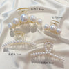 Clear simulated pearl hair claws in various lengths and styles displayed on a white fabric.