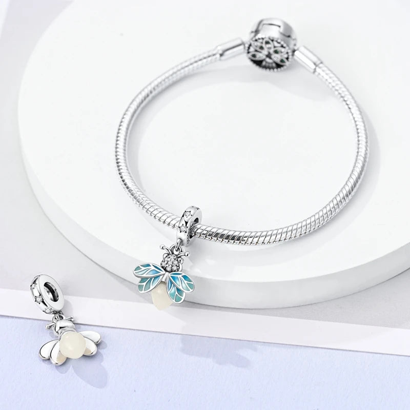 Sterling silver devil's eye charm bracelet with a silver clasp and a light blue floral pendant