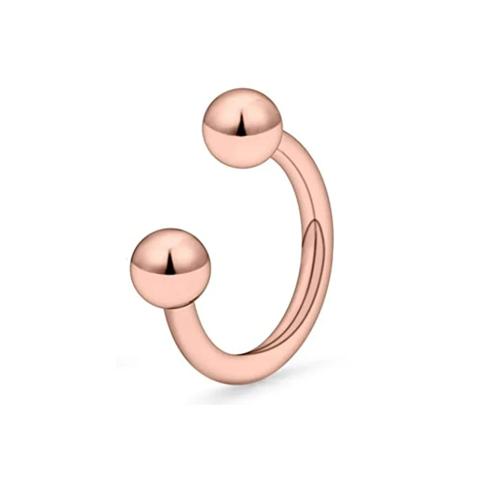 A close-up of a rose gold crystal horseshoe barbell ring set with spherical beads.