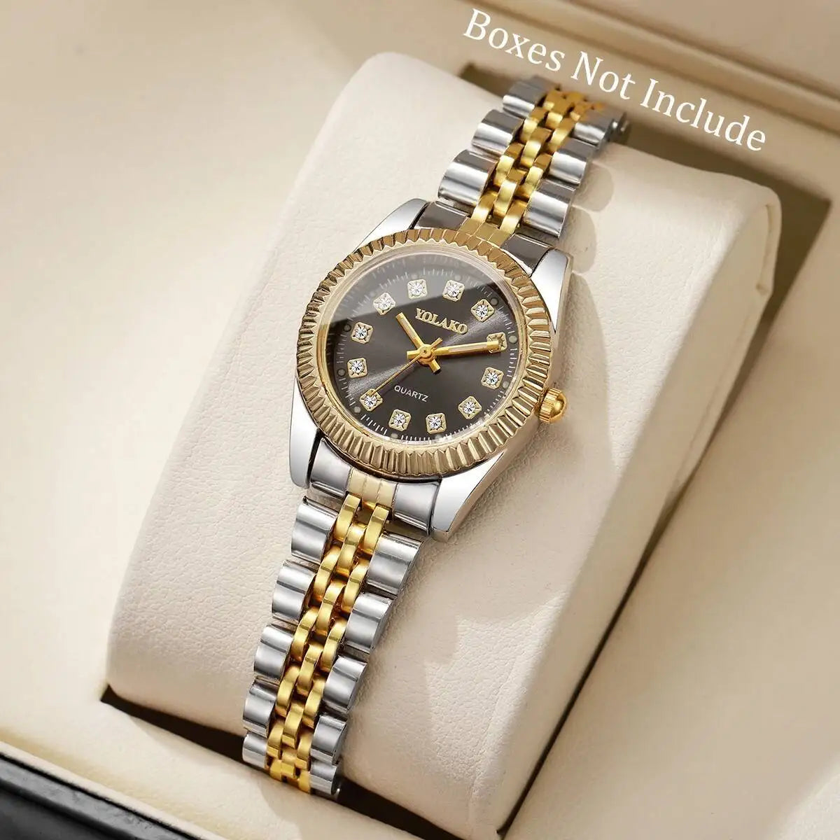 A silver and gold-toned YOLAKO quartz wristwatch with a black dial and textured strap is displayed on a light background.
