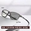 A pair of clear photochromic reading glasses resting on a white surface.