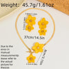 A gold-colored floral pendant necklace and earring set featuring yellow flowers on a white background.