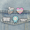 A denim shirt featuring enamel pins with funny work quotes like I just work here and not the worst employee.