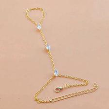 Gold-toned multilayer vintage ball link finger bracelets with clear stones displayed on a neutral background.