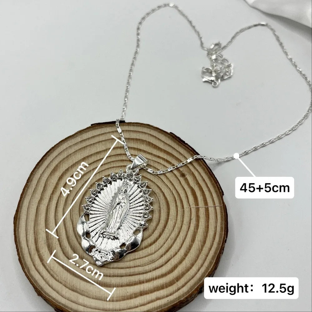 A dainty golden Christian necklace is displayed on a wooden slice, showing its size and weight.