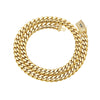 A thick gold Cuban link chain necklace with a diamond-encrusted clasp.