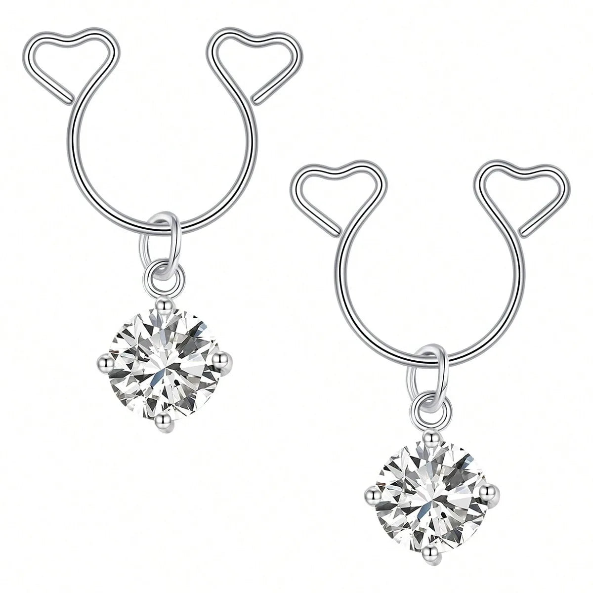 A pair of silver heart dangle non-piercing nipple rings featuring cubic zirconia stones.