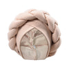 A light beige braided turban cap made of soft fabric, shown in a round shape.