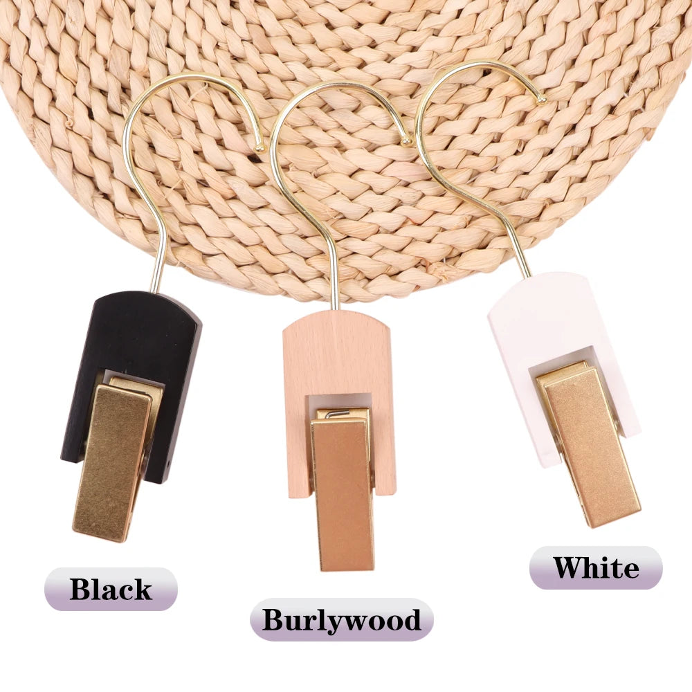 Three wooden wig and hair extension holders in black, burlywood, and white.