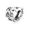 A silver heart-shaped charm featuring a delicate family tree design and the inscription Love You Mom