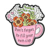 A pink enamel mug featuring a floral design and the text Don't forget to fill your own cup.