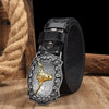 A black vintage western leather belt with a detailed gold-colored animal print buckle resting on a wooden surface.