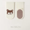Pair of white socks featuring a brown fox face and a grid pattern design.