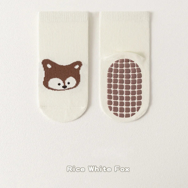 Pair of white socks featuring a brown fox face and a grid pattern design.