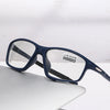 A pair of dark blue photochromic reading glasses resting on a white surface.
