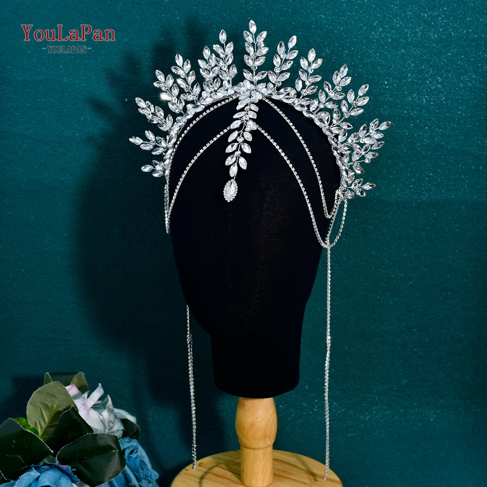A black mannequin head is adorned with a sparkling silver rhinestone bridal crown headband featuring delicate leaves and drap