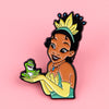 A colorful enamel pin featuring a smiling woman with bright yellow hair and green clothing.