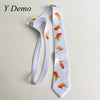 A white long neck tie featuring a repeating pattern of orange goldfish prints.