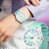 A close-up of a white and teal quartz fashion watch on a wrist, with a hand adjusting the watch.