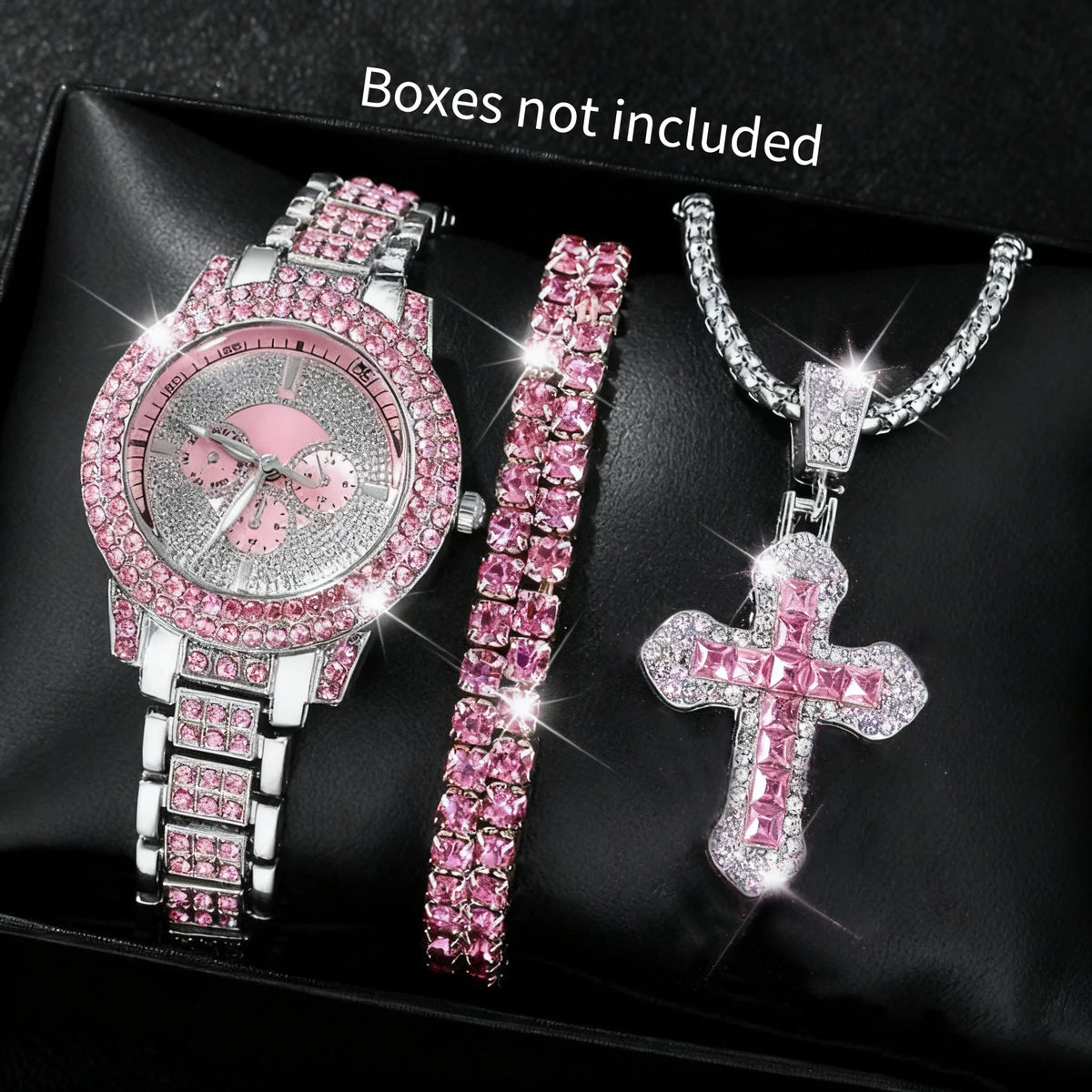 A set of three pink and silver diamond rhinestone jewelry pieces including a watch, bracelet, and cross pendant displayed on 