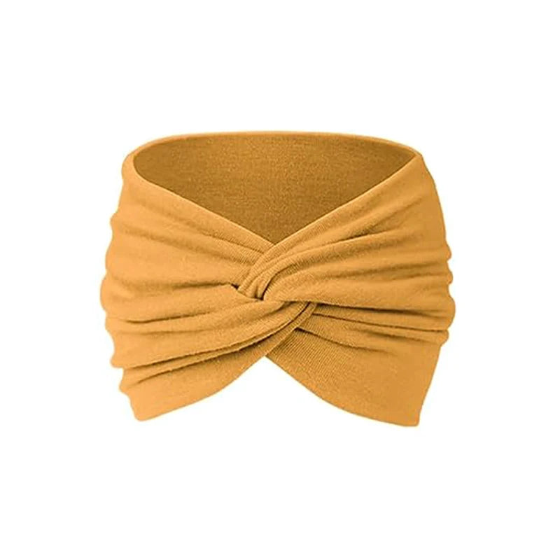 A mustard yellow fabric headband tied in a knot, suitable for yoga or sports.