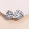 Two circular enamel lapel brooches featuring text related to matching energy and deserving the day