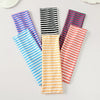 Une collection de bandeaux pour cheveux colorés à rayures, disposés sur une surface blanche.