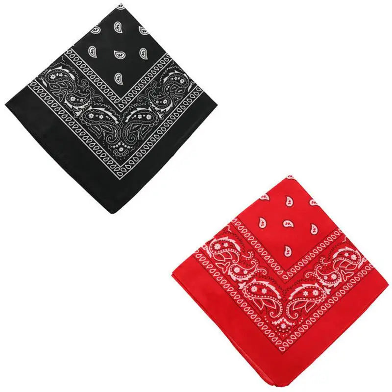 A black bandana scarf with white paisley and geometric patterns folded diagonally.