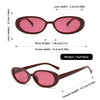 A pair of maroon cat eye sunglasses with pink lenses and brown frames shown in various dimensions.