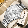 A silver and gold windup watch with a metal bracelet is displayed on a light-colored box.