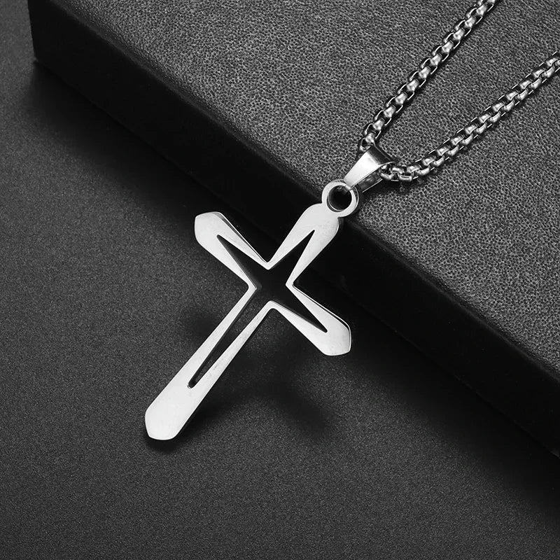 Silver retro Christian cross amulet necklace hanging on a dark surface