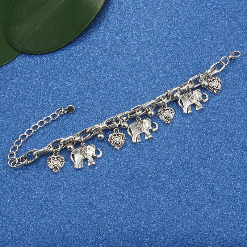 Silver charm bracelet featuring elephant and heart pendants on a silver chain