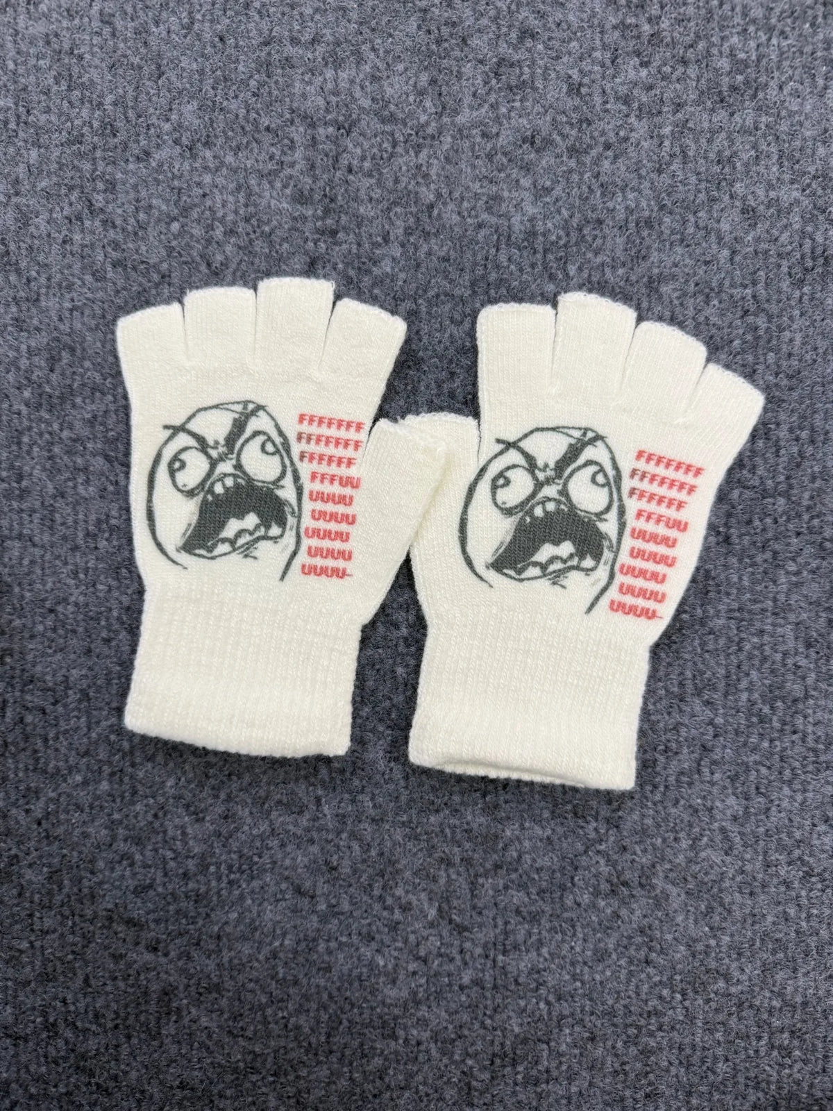 A pair of white fingerless knit gloves featuring a retro printed face design on the palm area.