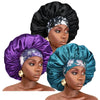 A model wears a purple satin sleep bonnet with an elastic band and a black satin sleep bonnet.