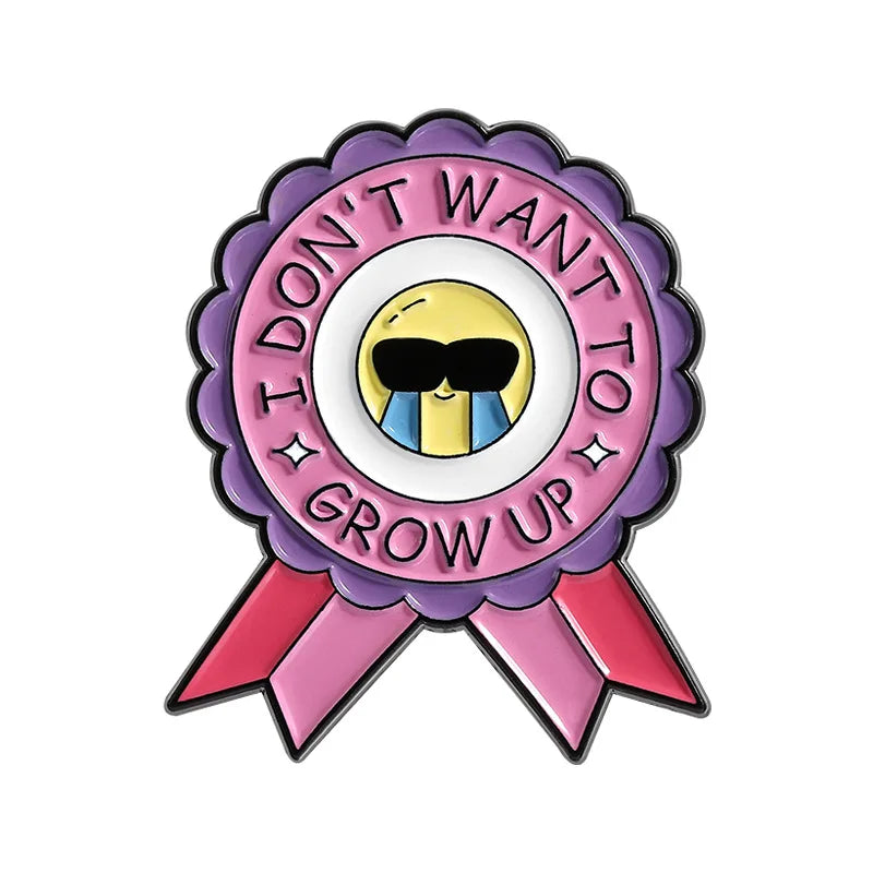 A lapel pin featuring a purple and pink rosette with the text Don't Want I Don't Grow Up